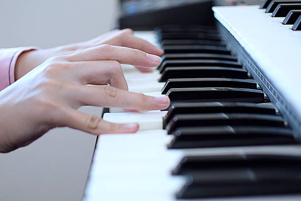 istock Selective focus girl hands playing piano 612398020