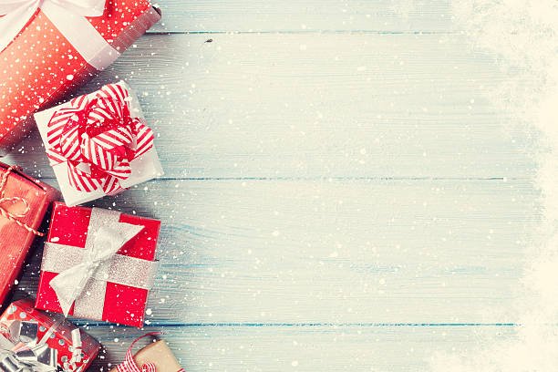 istock Christmas gift boxes on wooden table 612398424
