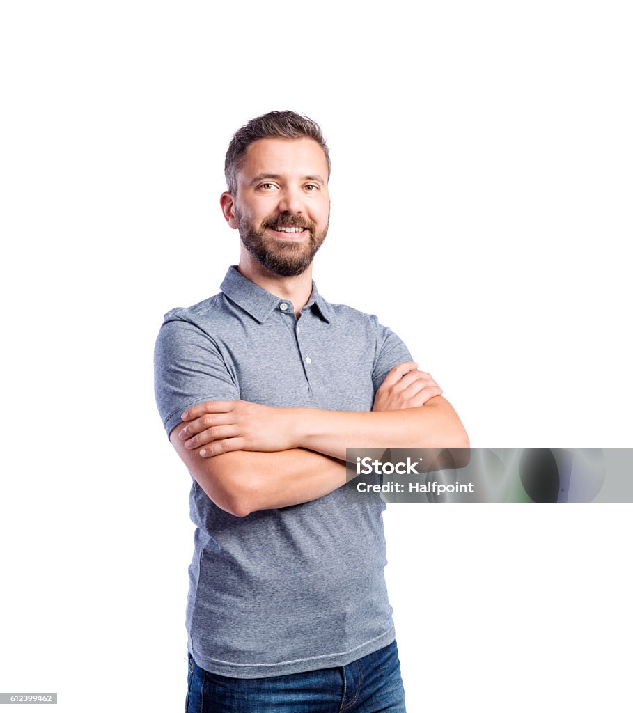 Hipster man in gray t-shirt, studio shot, isolated Young handsome hipster man in gray t-shirt, arms crossed, studio shot on white background, isolated Men Stock Photo