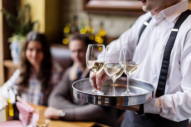 Serving wine Waiter serving white wine in restaurant waiter stock pictures, royalty-free photos & images