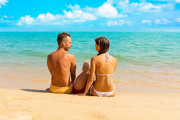 istock Family sitting in the beach 612400424