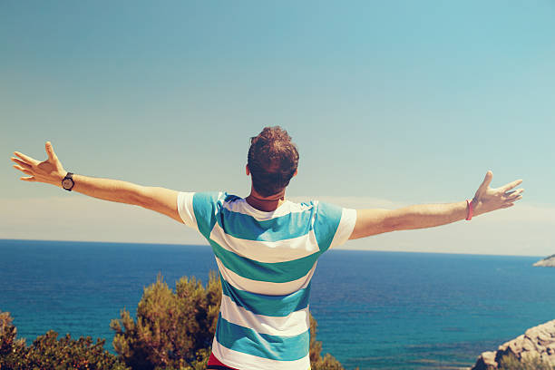 istock Man enjoying on the beach. 612400432