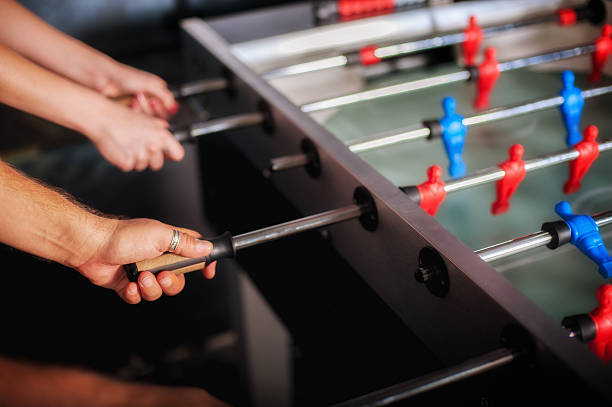istock Friends having fun playing table foosball 612400510