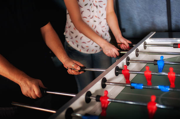istock Friends having fun playing table foosball 612400952