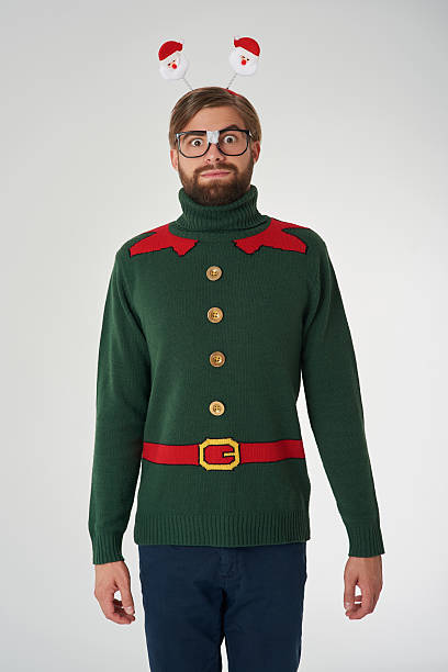 Cheerful man and Christmas cardigan Cheerful man and Christmas cardigan christmas nerd sweater cardigan stock pictures, royalty-free photos & images