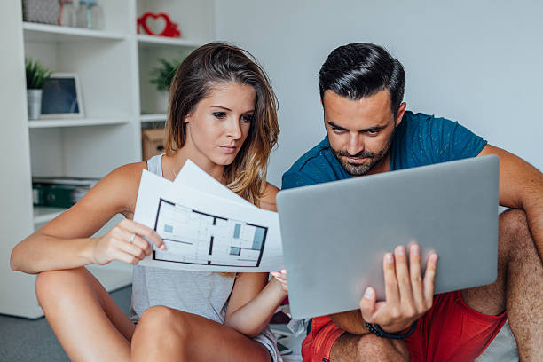 Young couple is using laptop pc while woman stock photo