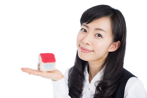 Businesswoman holding a model house