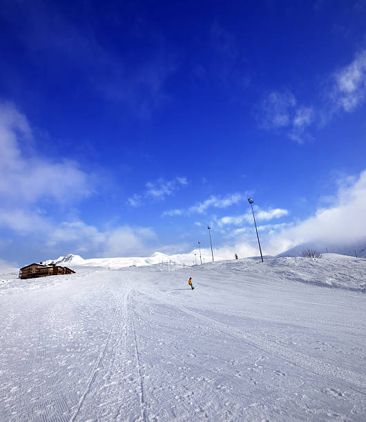 istock Snowboarder on ski slope in nice sun day 612406566