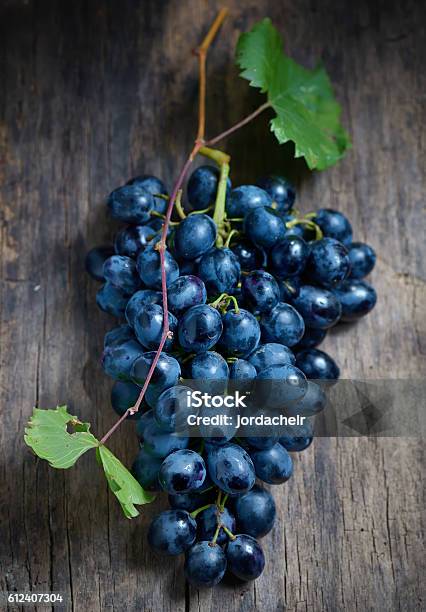 Bunch Of Red Grapes On Wooden Background Stock Photo - Download Image Now - Blue, Close-up, Dessert - Sweet Food