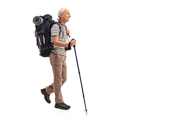 istock Elderly male hiker walking 612407744