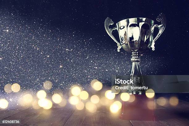 Low Key Image Of Trophy Over Wooden Table Stock Photo - Download Image Now - Award, Trophy - Award, Success