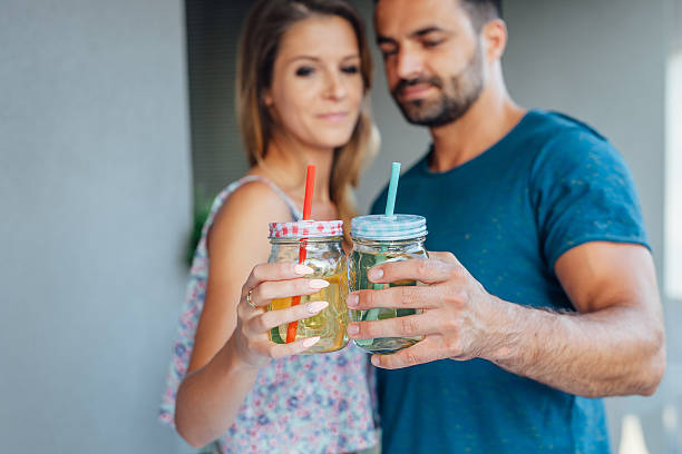 istock Young couple are standing and drinking a water. 612409508
