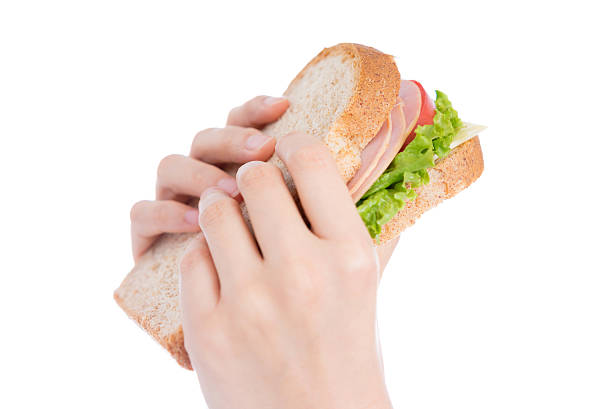 istock Person holding a BLT sandwich 612414588