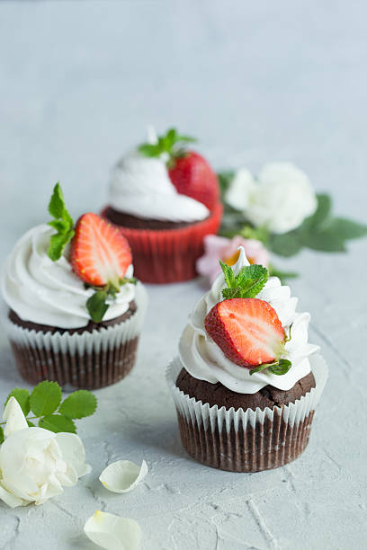 istock Chocolate cupcakes with strawberry 612415350