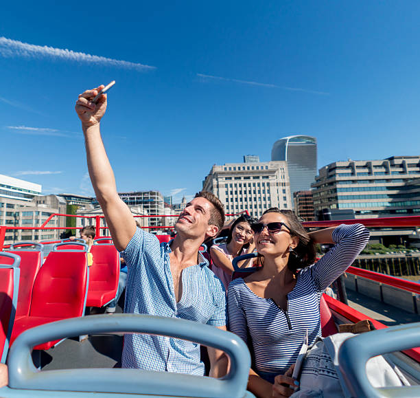 istock Couple taking a selfie on a tour bus 612415750