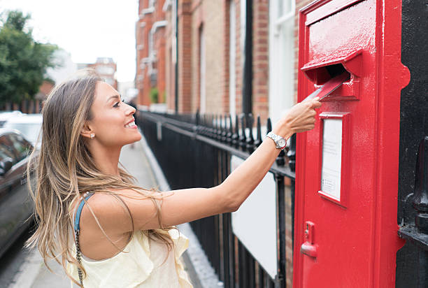 istock Woman sending letter through the mail 612417984
