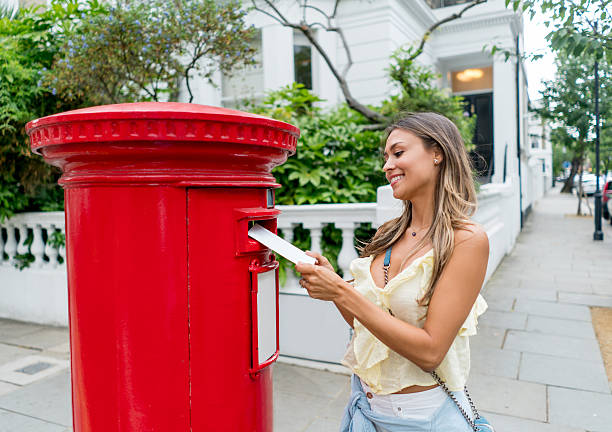 istock Woman sending postcard through the mail 612418106