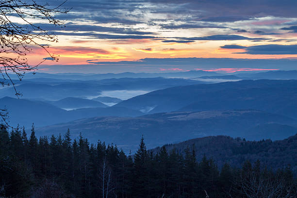 istock sunrise and mist on mountain dark 612420216