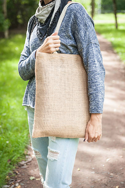 istock Woman holding empty canvas bag. Template mock up 612420342