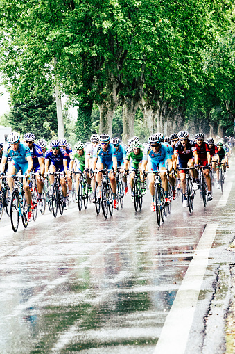 Saint Remy de Provence, France - July 20, 2014: Riders in the Tour de France 2014 entering the town of Saint Remy de Provence in the south of France during a rain storm. The light blue jerseys are the Astana team from Kazakhstan.