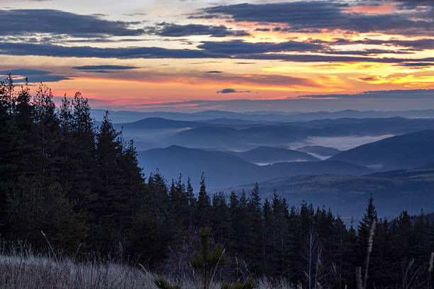 istock sunrise and mist on mountain dark 612478550