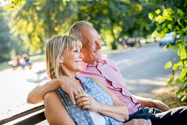 istock Happy couple relaxing at the park 612478954
