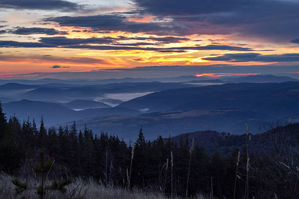 istock sunrise and mist on mountain dark 612479012