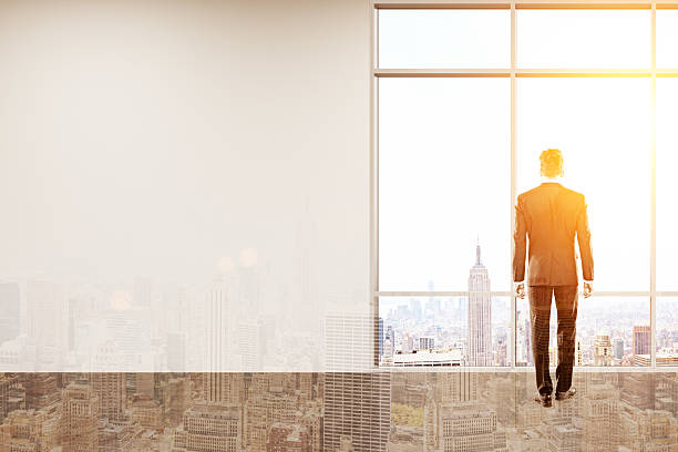 istock Businessman looking at city 612480080