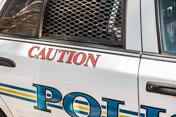 istock Caution decal on side of police car 612480126