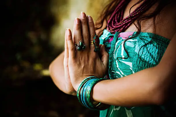 woman practice yoga outdoor close up of hands in namaste gesture