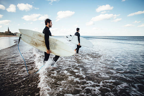 istock Two Surfers Walking Out into the Sea 612481266