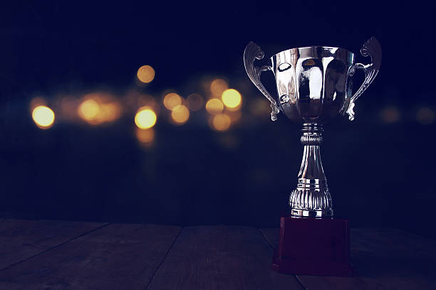 istock low key image of trophy over wooden table 612481932