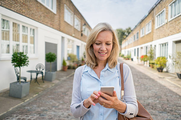 istock Woman using app on her mobile phone 612482442