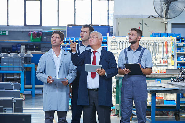 istock Supervisor and workers in factory 612482546