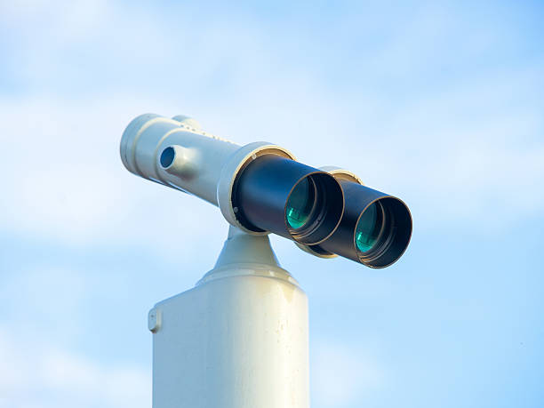 istock Stationary binocular against clear blue sky 612483494
