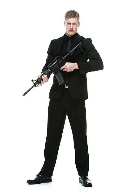 istock Businessman holding machine gun 612483662