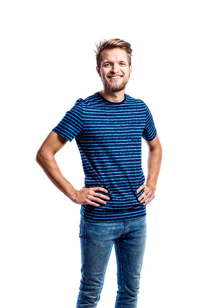 hipster man in jeans and t-shirt, studio shot, isolated - hand on hip imagens e fotografias de stock