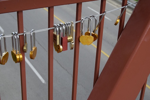 Niagara Falls, ON Canada – September 18, 2016: closeup of Love Locks hanging  at the Lock Bridge a pedestrian bridge crossing Portage road in Niagara Falls, Ontario 