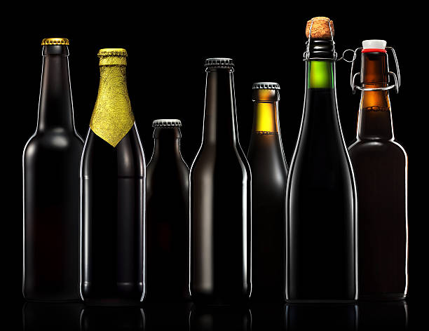 istock Set of beer bottles isolated on black background 612488584