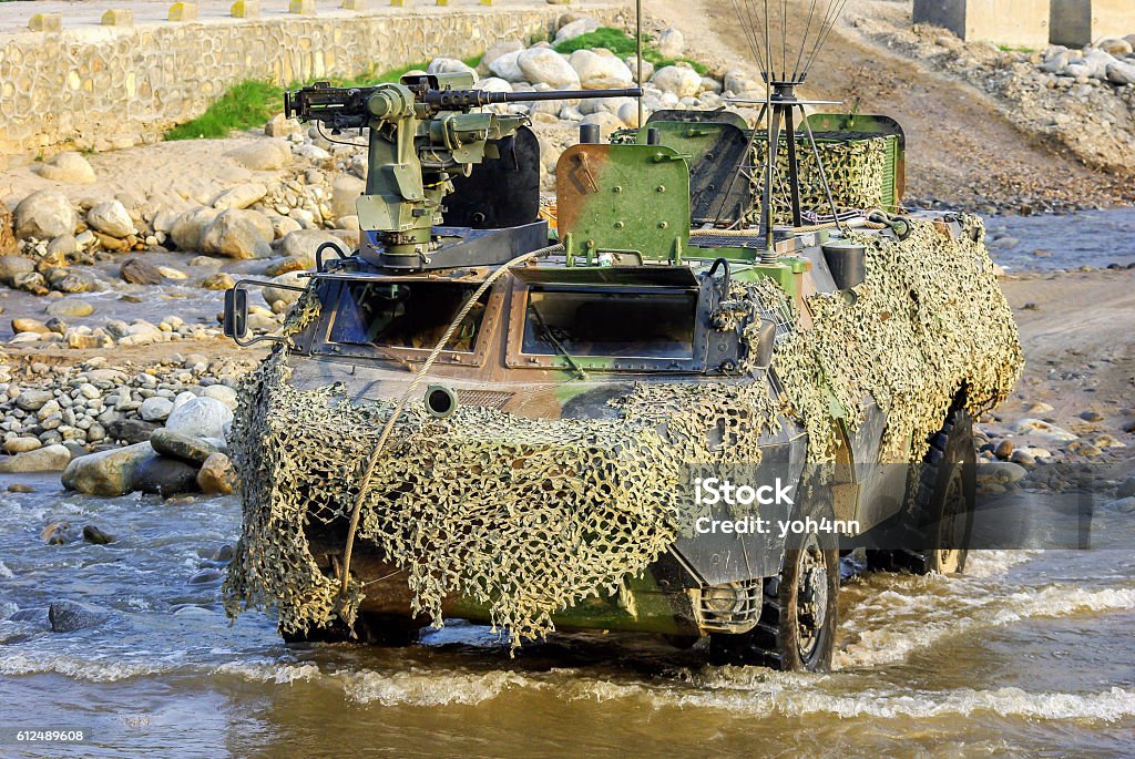 Armored vehicle Horizontal color image of an military armored vehicle moving through river during sunny day. French Army Stock Photo