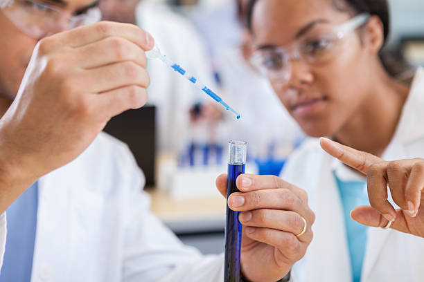 istock Close up of scientists working in la 612490970