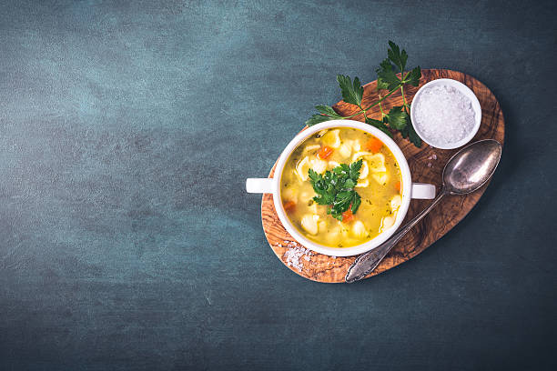 Chicken soup with noodles Chicken soup with noodles and parsley chicken soup stock pictures, royalty-free photos & images