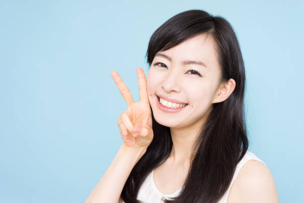 istock Woman giving peace sign 612493644
