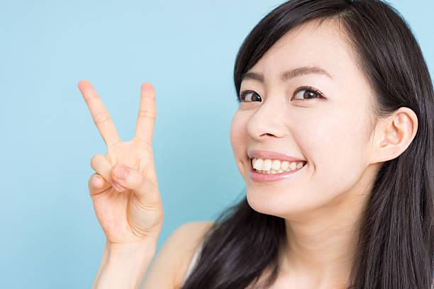 istock Woman giving peace sign 612493772