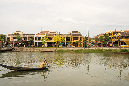 Hoi An, Vietnam - May 28, 2016: The fisherman on the boat on the Thu Bon river at Hoi An ancient town