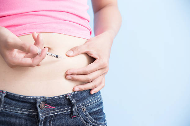 istock Woman inject to belly 612494658