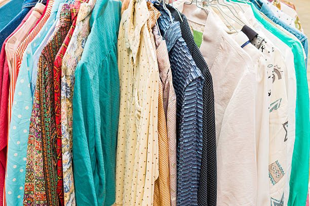 istock clothes hanging on a rack in a flea market 612496436