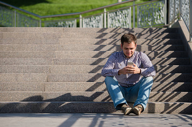 istock people, style, technology and lifestyle - young man with smartphone 612496640