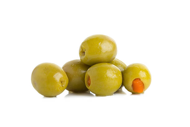 istock Green olives stuffed with red paprika isolated on white 612498008
