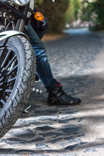istock Man sat on motorcycle  the road during sunrise. 612499872